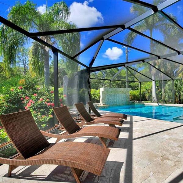 large inground pool with a line of chairs nearby